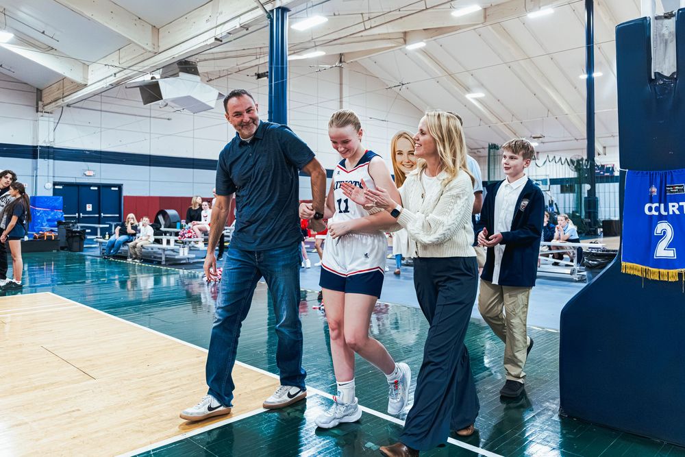 Family walking with daughter during Senior Night