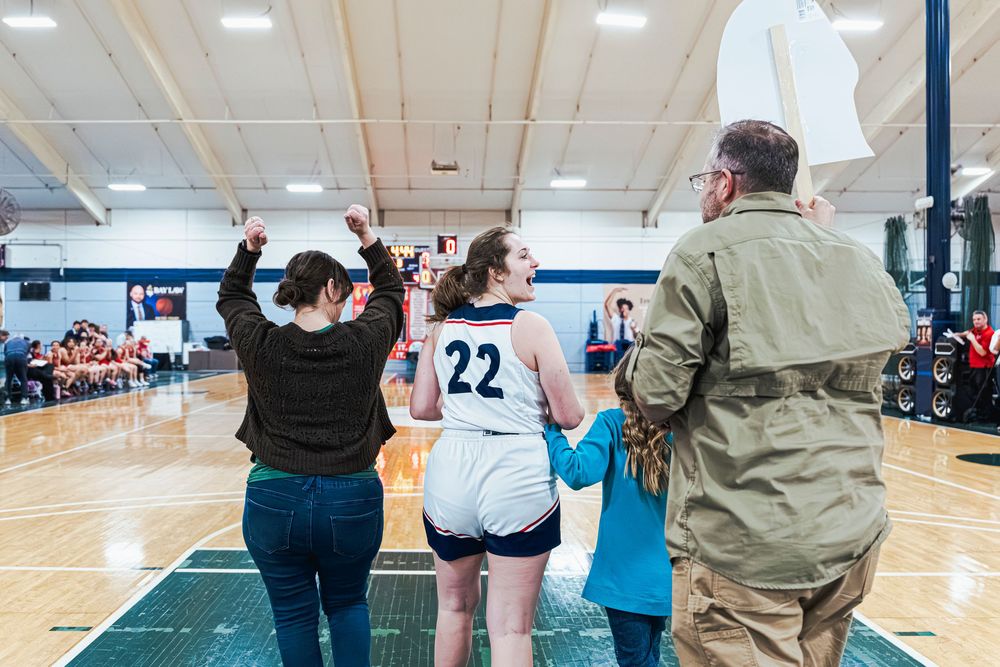 Family walking with daughter during Senior Night