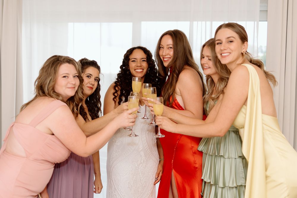 the bridal party share a toast in their hotel room