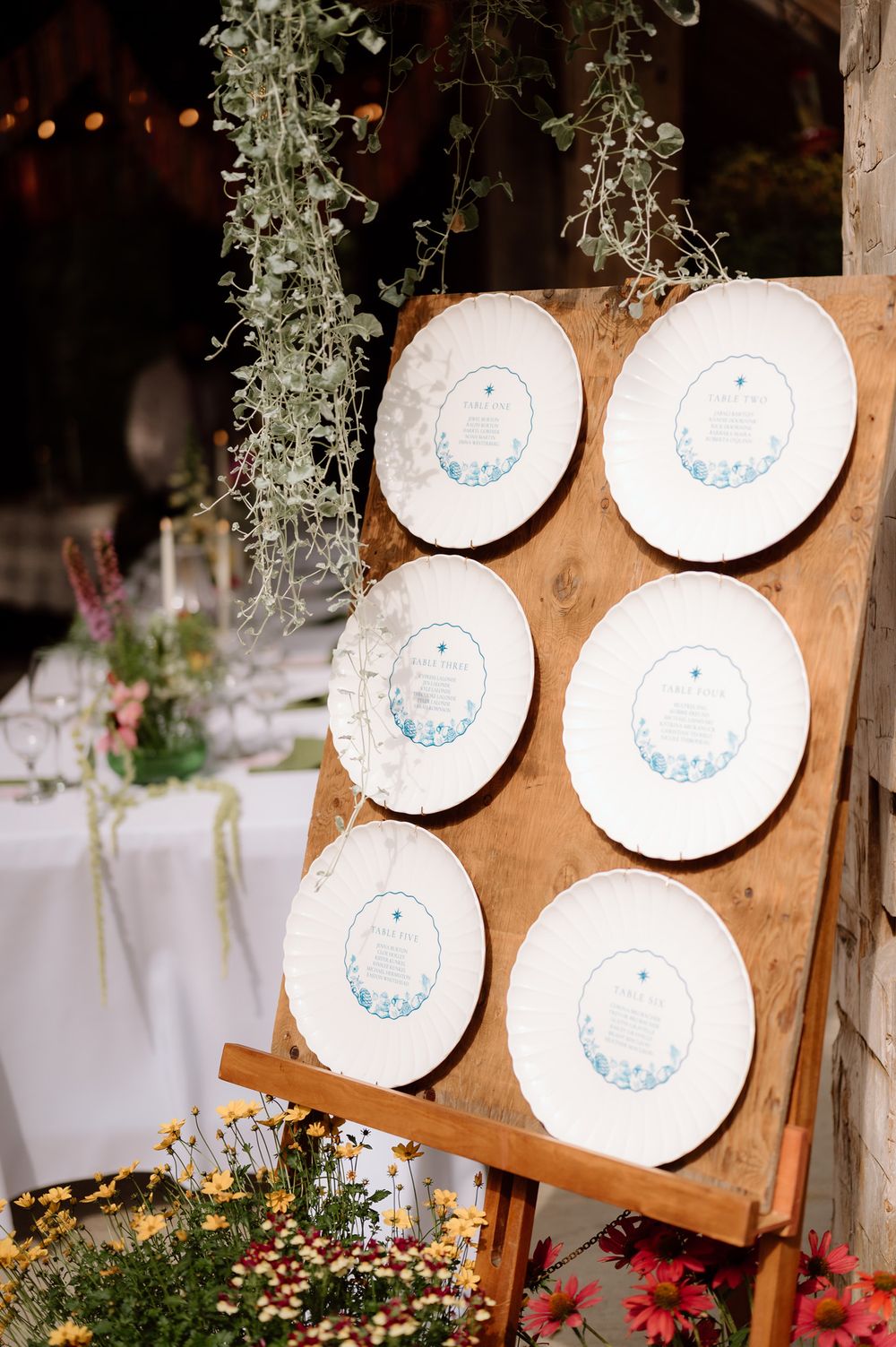 vintage plates used as a seating chart for a wedding