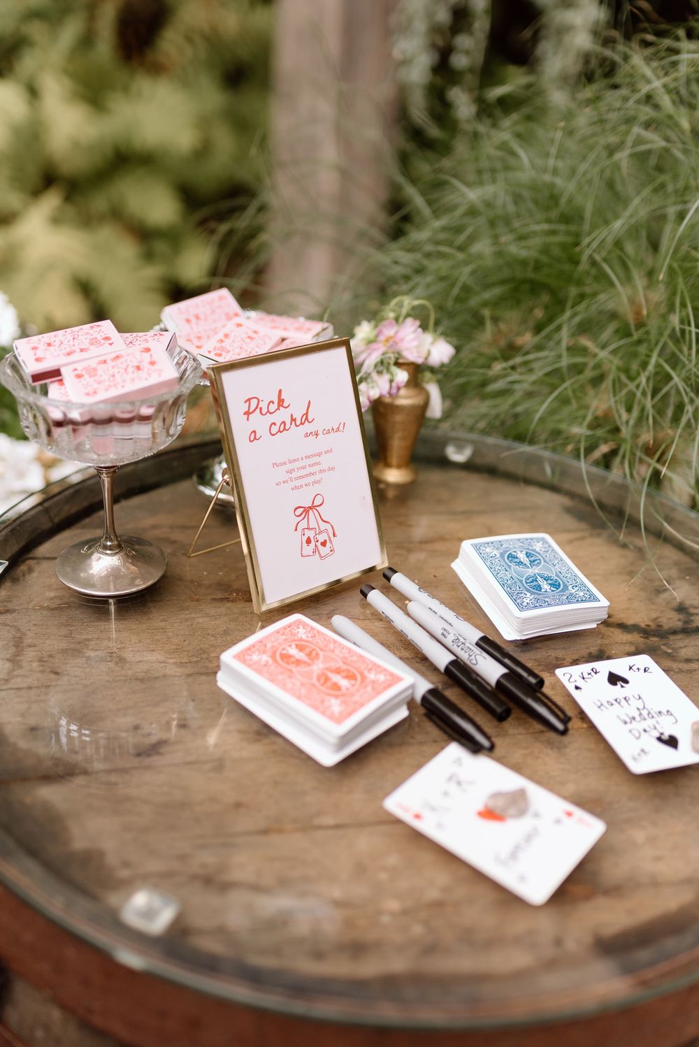 a decor station where wedding guests can write marriage advice on playing cards for the bride and groom