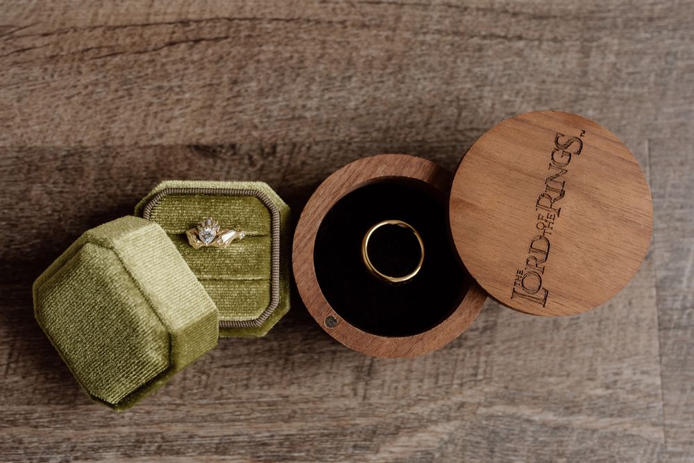 detail shot of the wedding rings featuring a lord of the rings ring holder