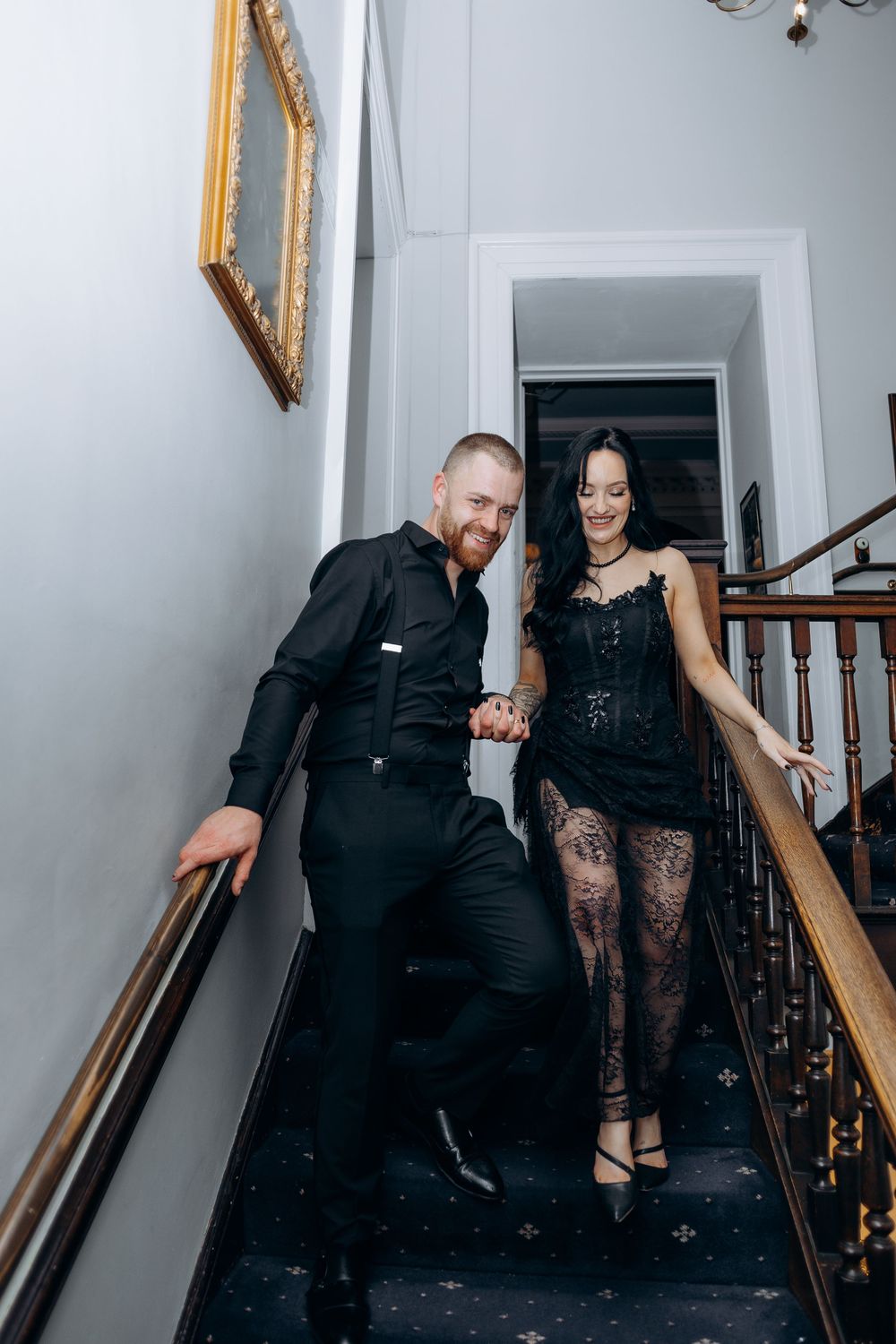 Couple in formal black attire playfully posing on a staircase in a sequence of candid moments.