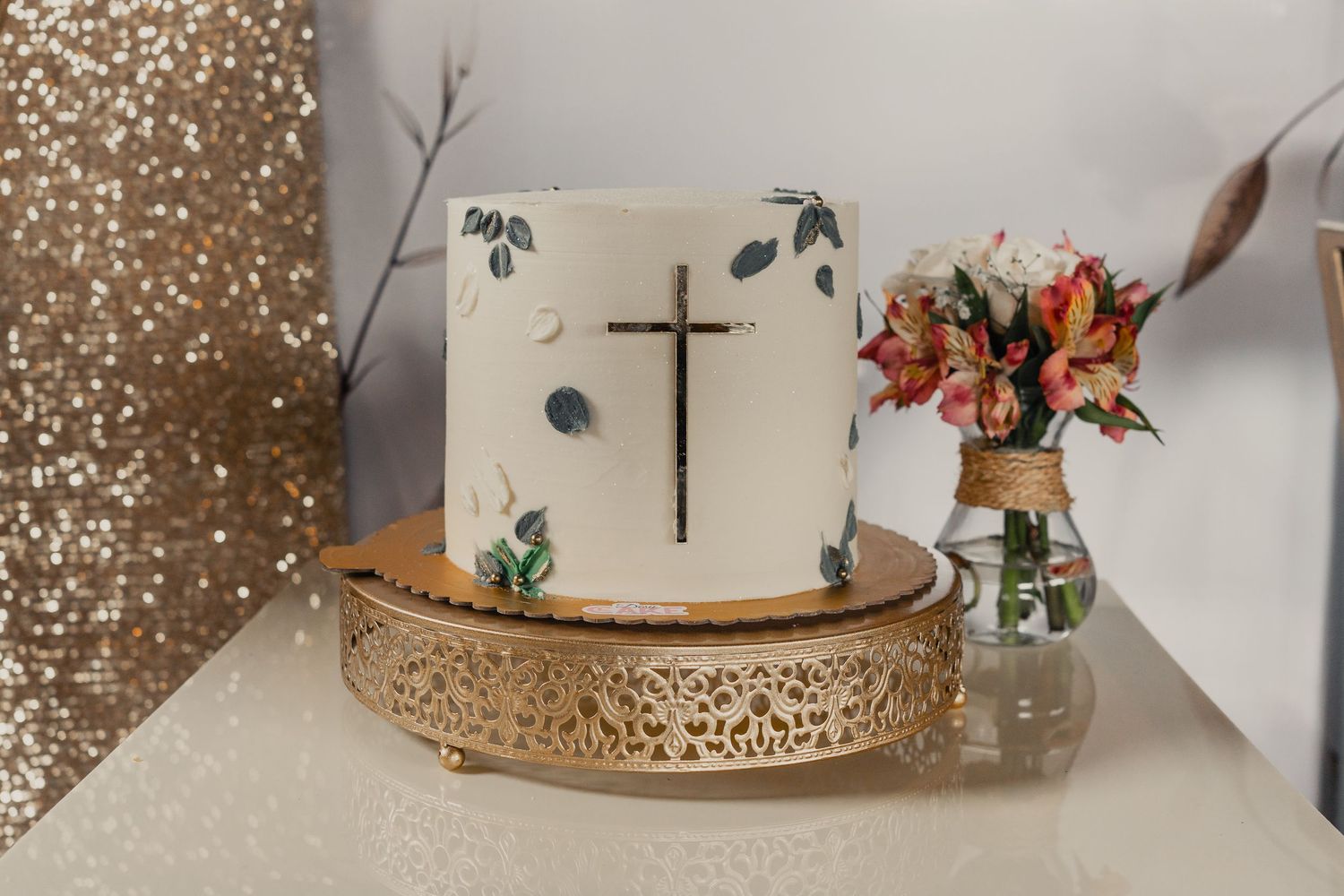 A series of elegant white wedding cakes decorated with floral arrangements and displayed on ornate gold stands.