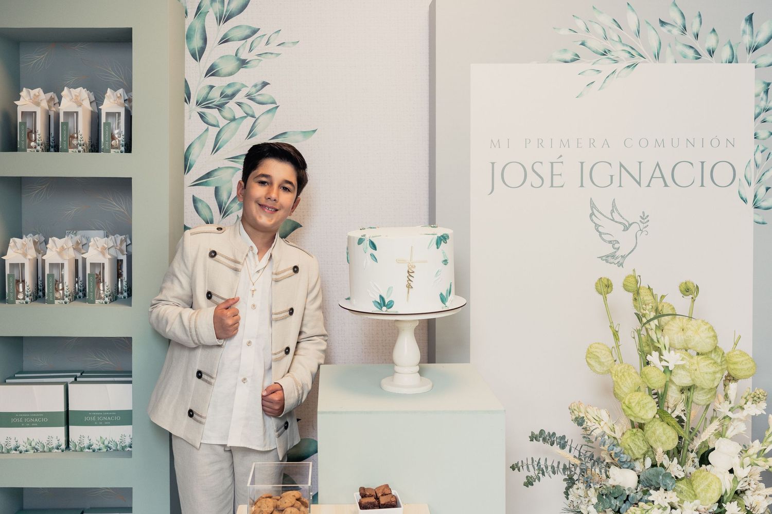Elegant floral decor and white bottles displayed on shelves with green leaf wall art in a modern retail space.