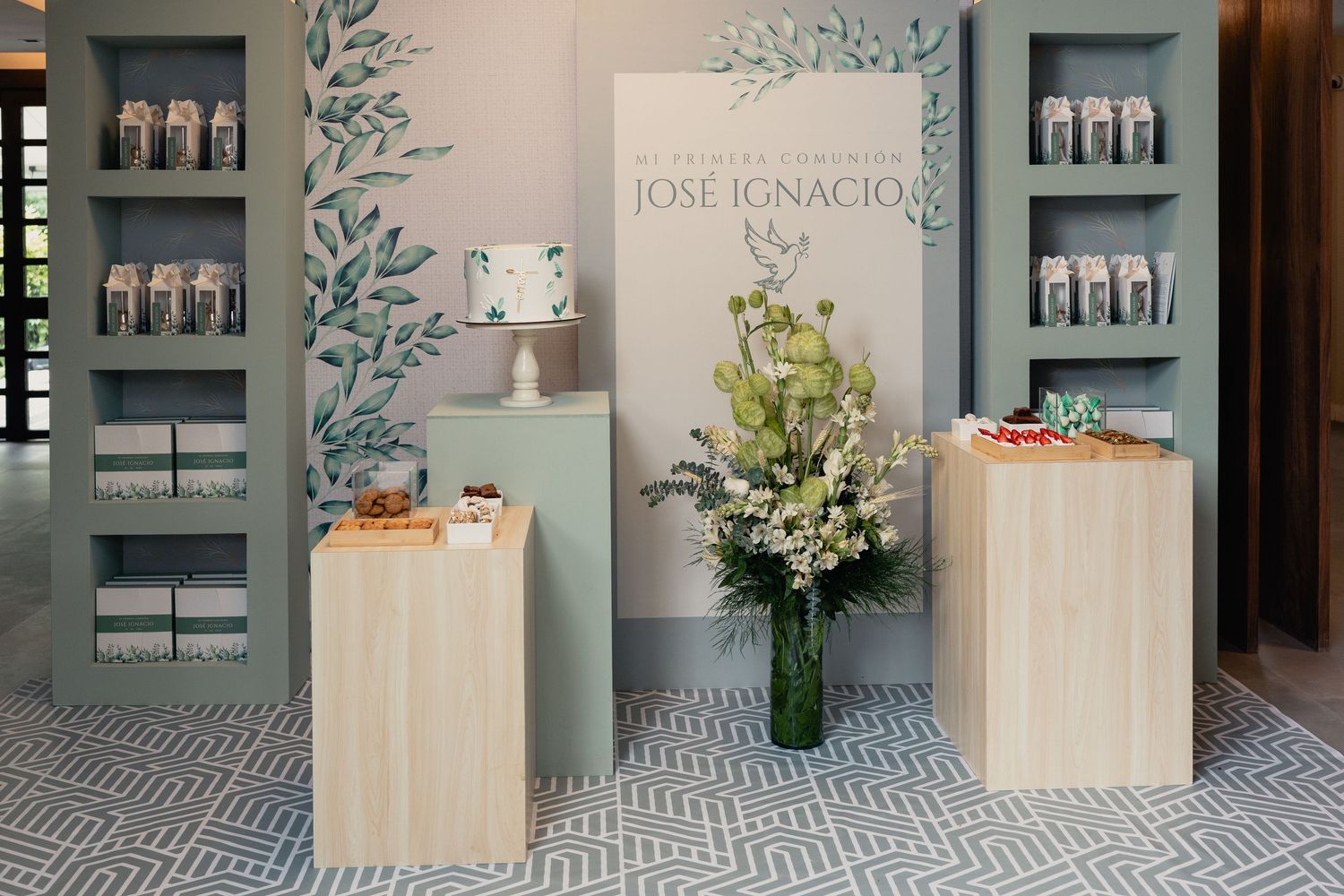 Modern spa interior with wooden display pedestals, floral arrangement, and gray walls featuring built-in product shelving.