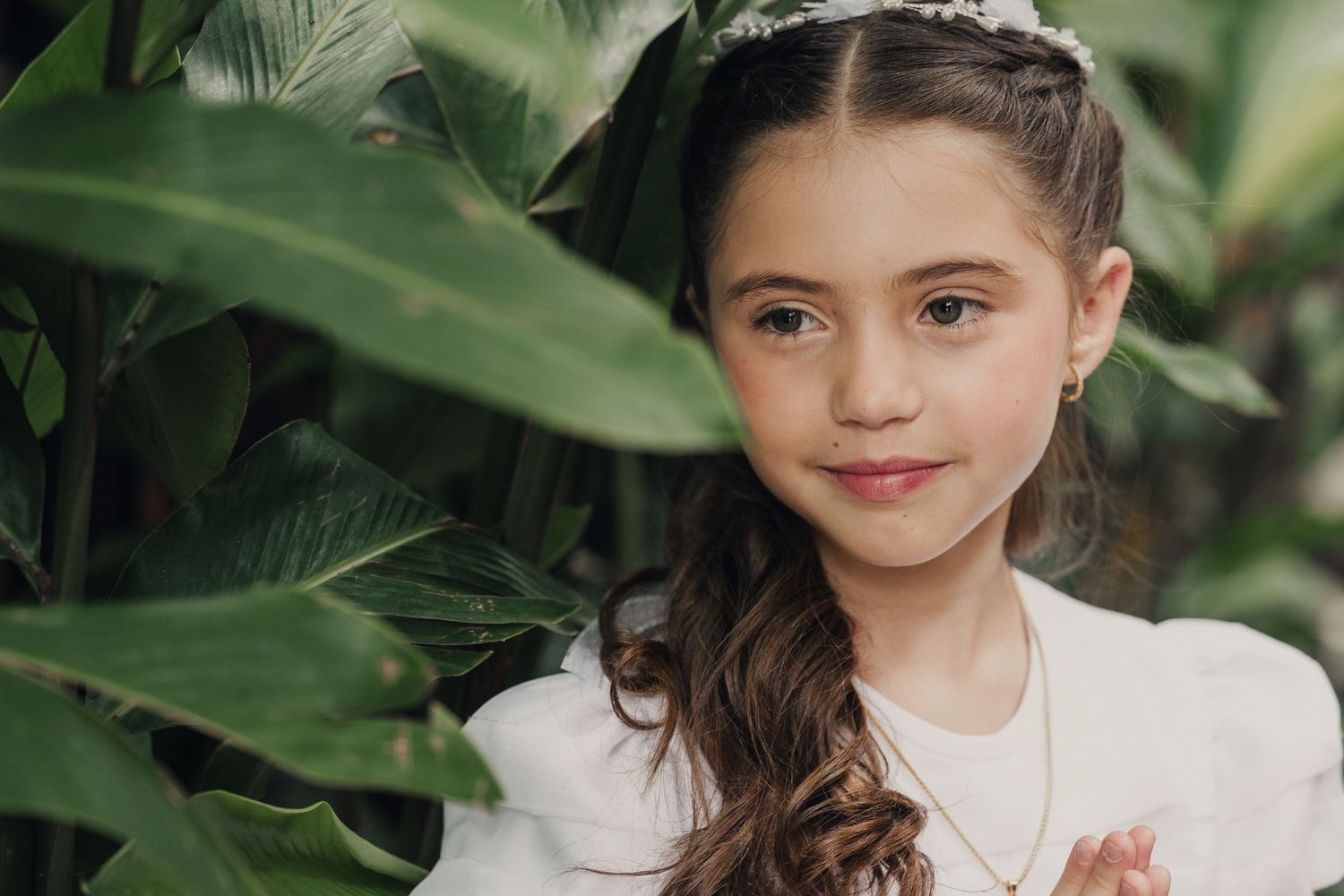 A series of outdoor portraits in a lush green garden setting with natural lighting and foliage backdrop.