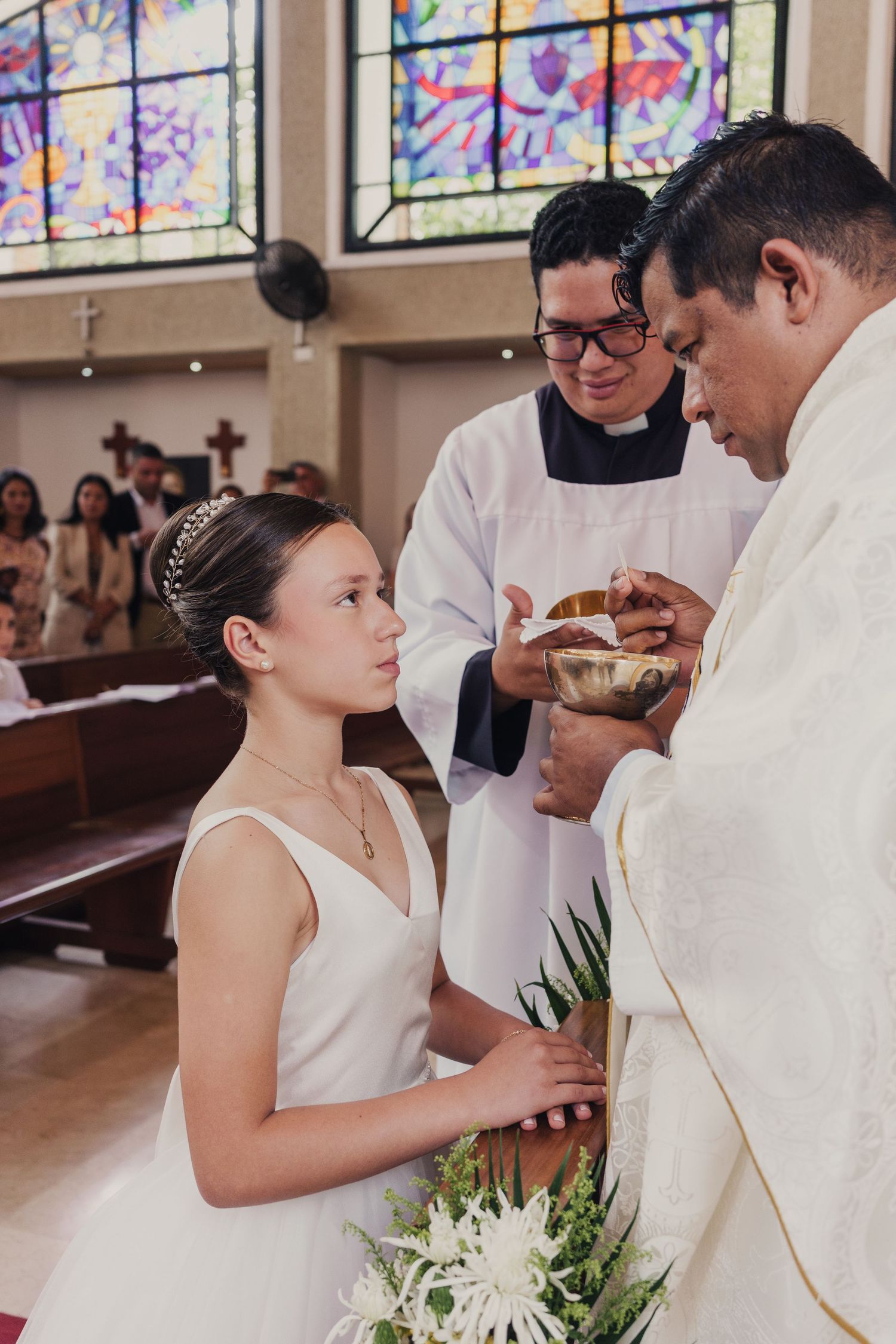 A wedding ceremony sequence showing a couple exchanging rings in a church with stained glass windows in the background.