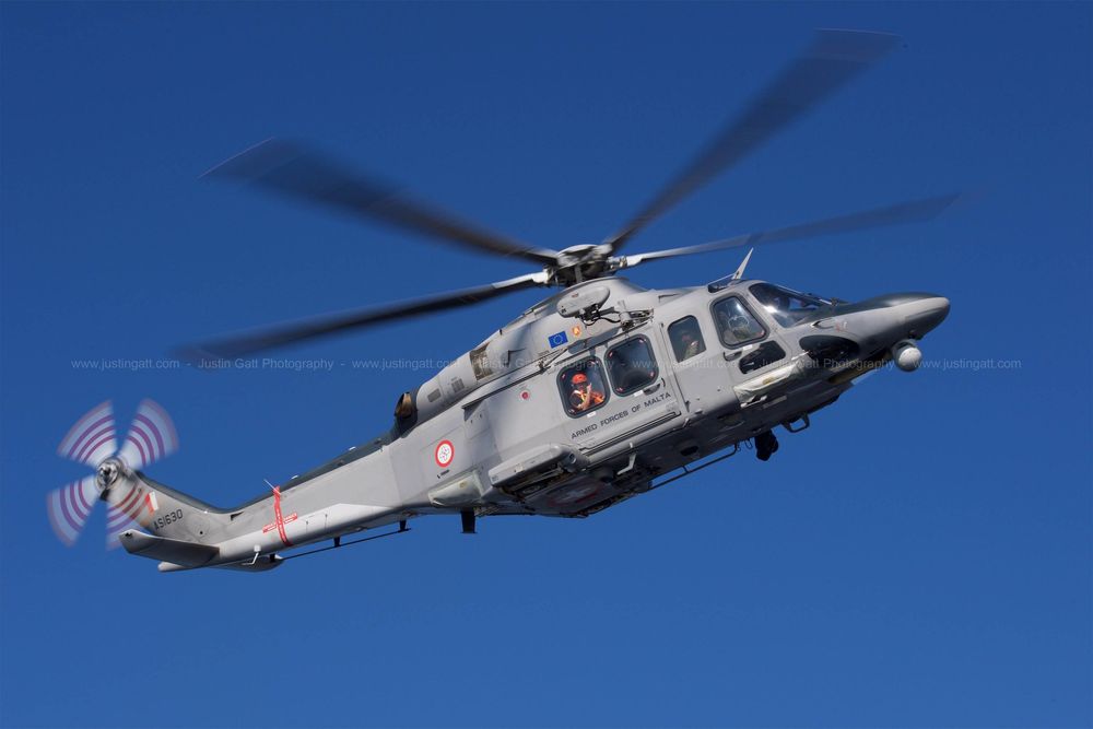 Military helicopters flying in formation against clear blue sky during aerial demonstration.