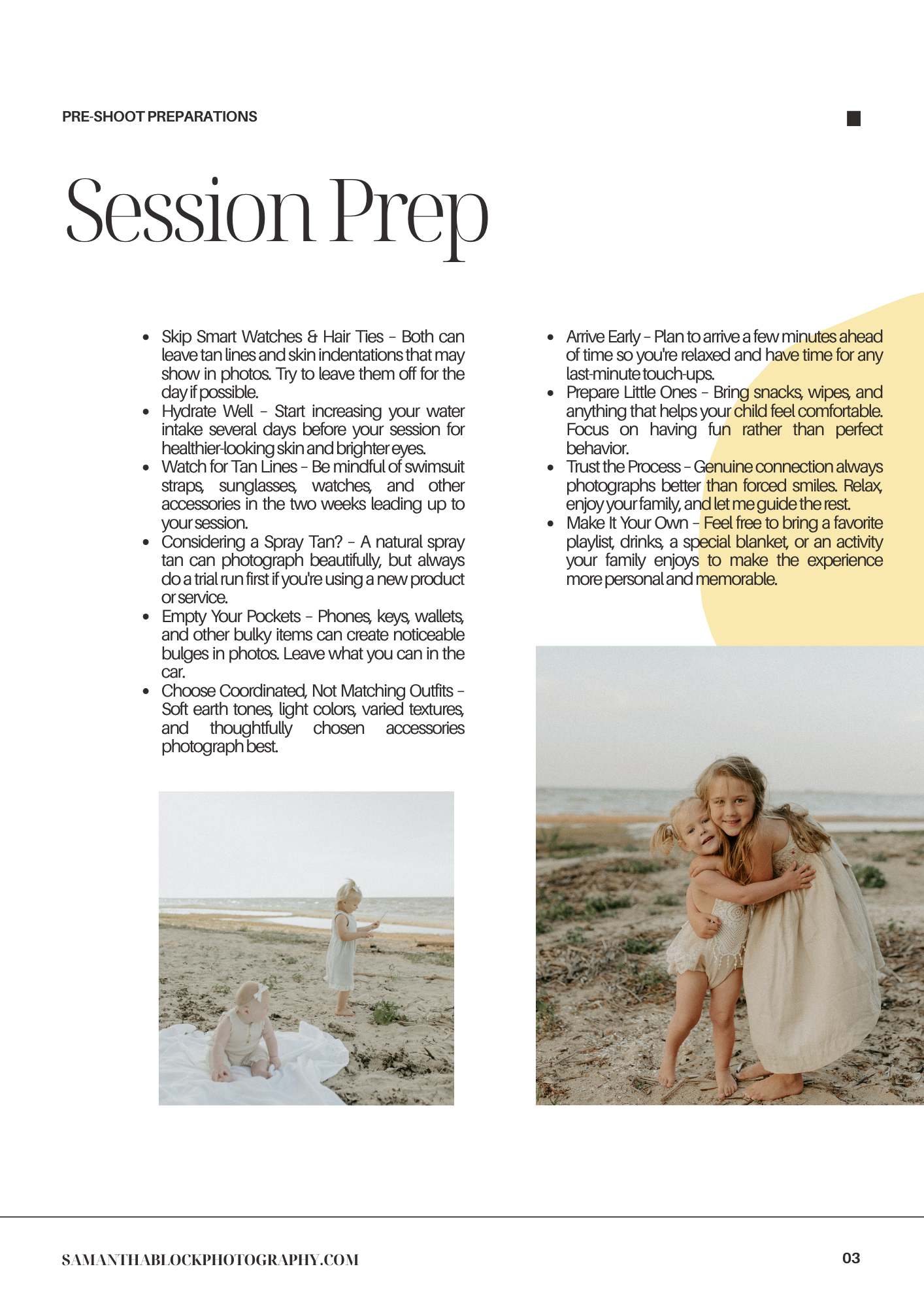 A young girl in a white dress sits on a sandy beach surrounded by rocks during a professional photography session.