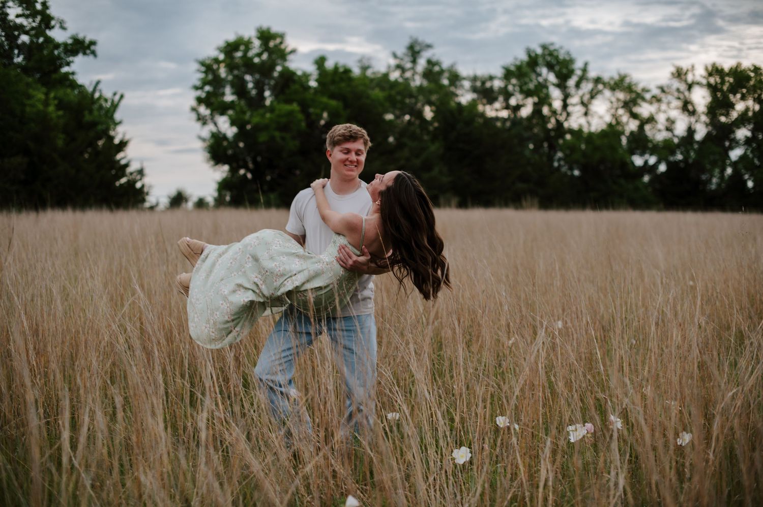 Wichita KS outdoor engagement photos in nature location Andover, couple photos in field with flowers, small elopement wedding photographer