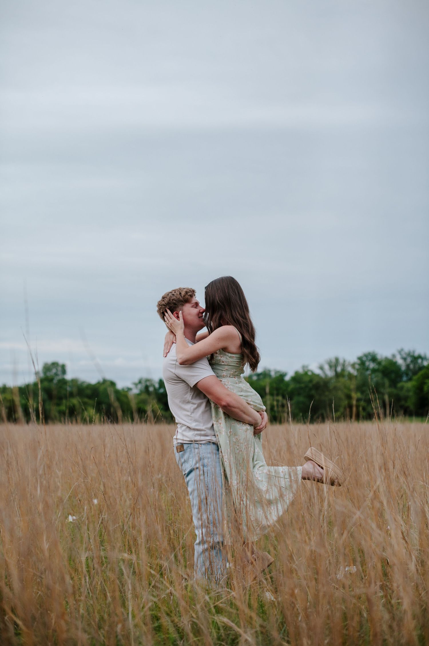 Wichita KS outdoor engagement photos in nature location Andover, couple photos in field with flowers, small elopement wedding photographer