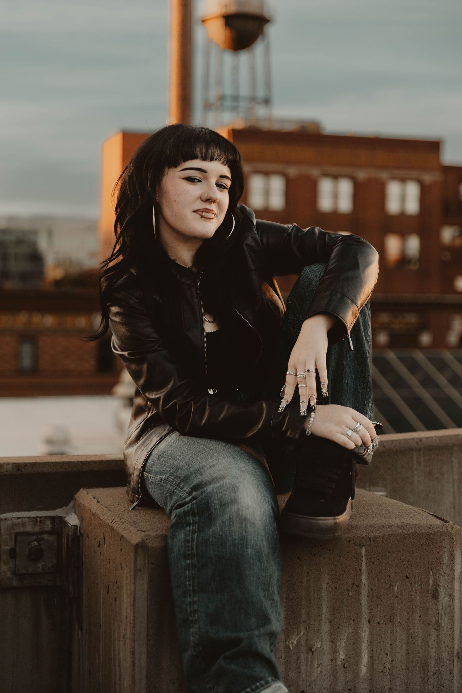 Girl sits down and poses for senior photos, cinematic photos, urban photos, and portraits in Denver, Colorado outside and in nature photo