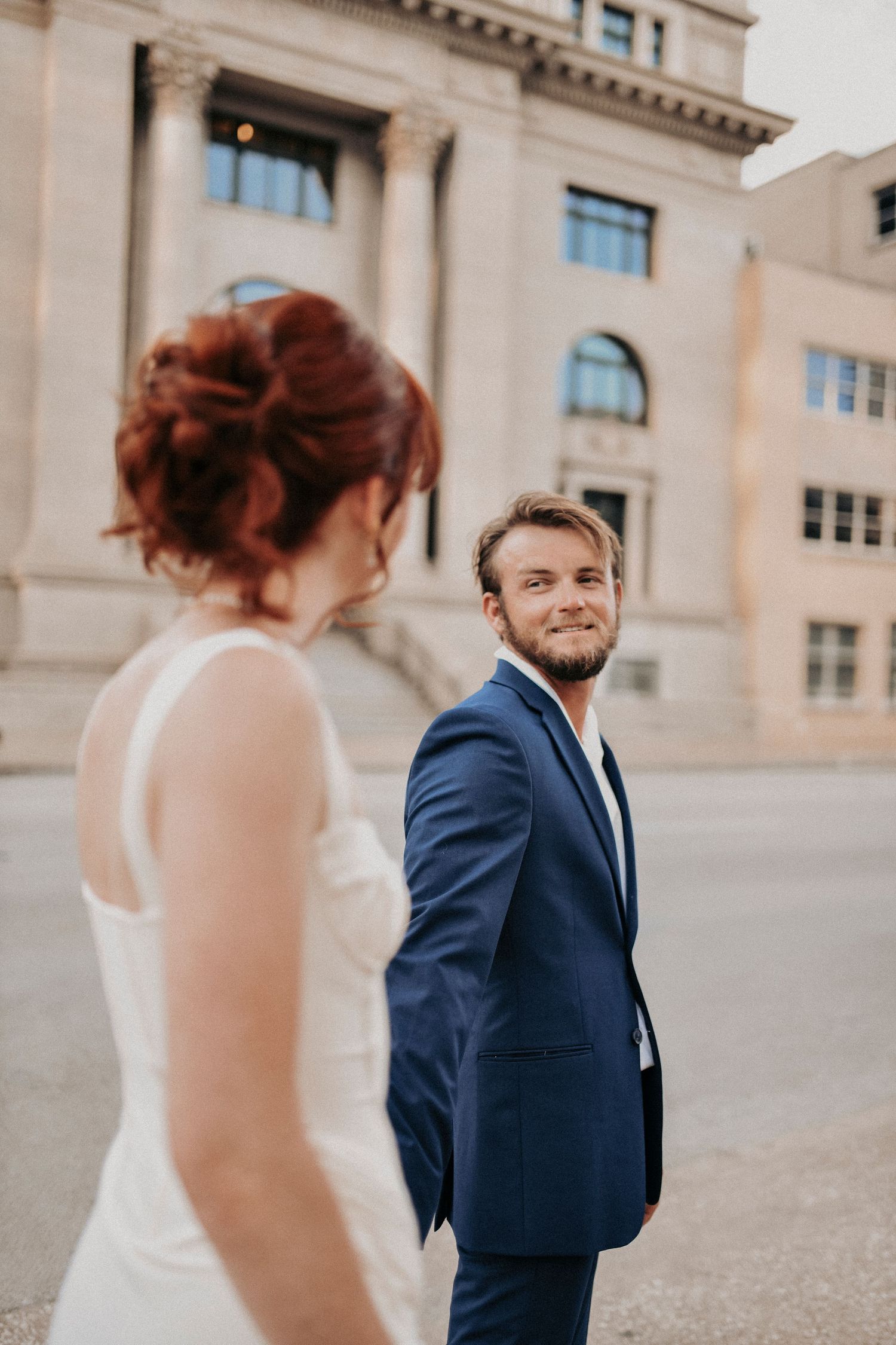 Romantic engagement portraits with limestone walls in Downtown Dallas