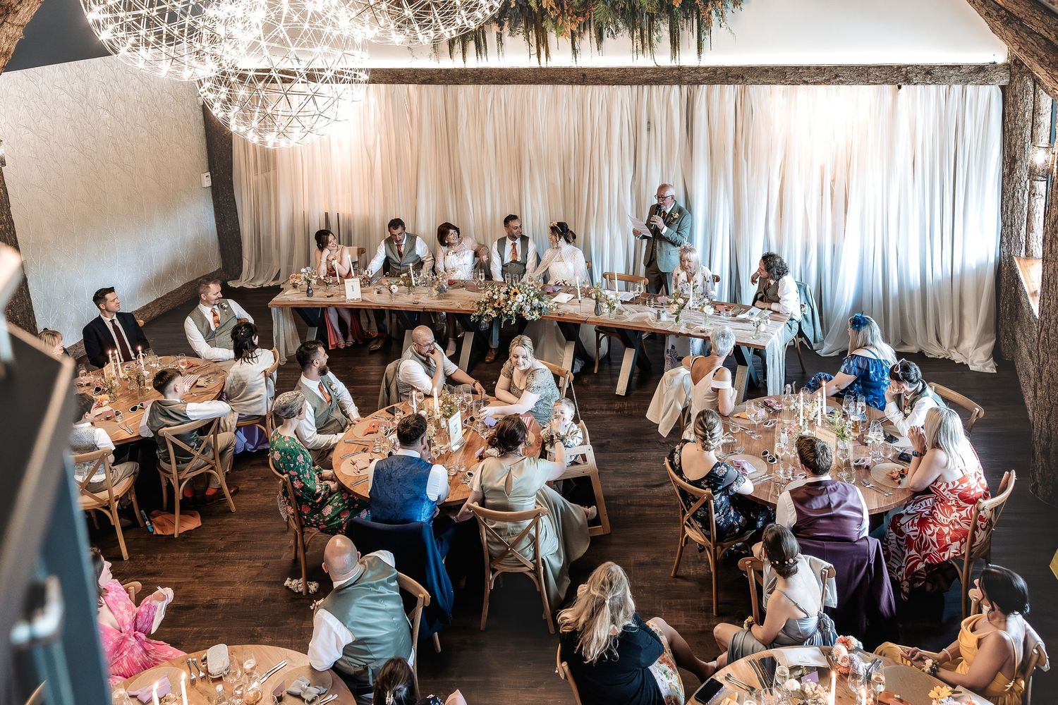 Wedding guests interacting relaxed atmosphere during speeches
