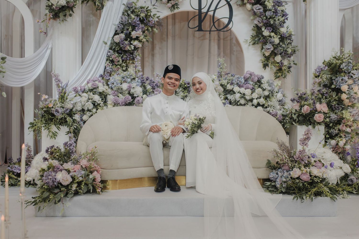 A romantic garden scene with white architectural elements and lush greenery.
