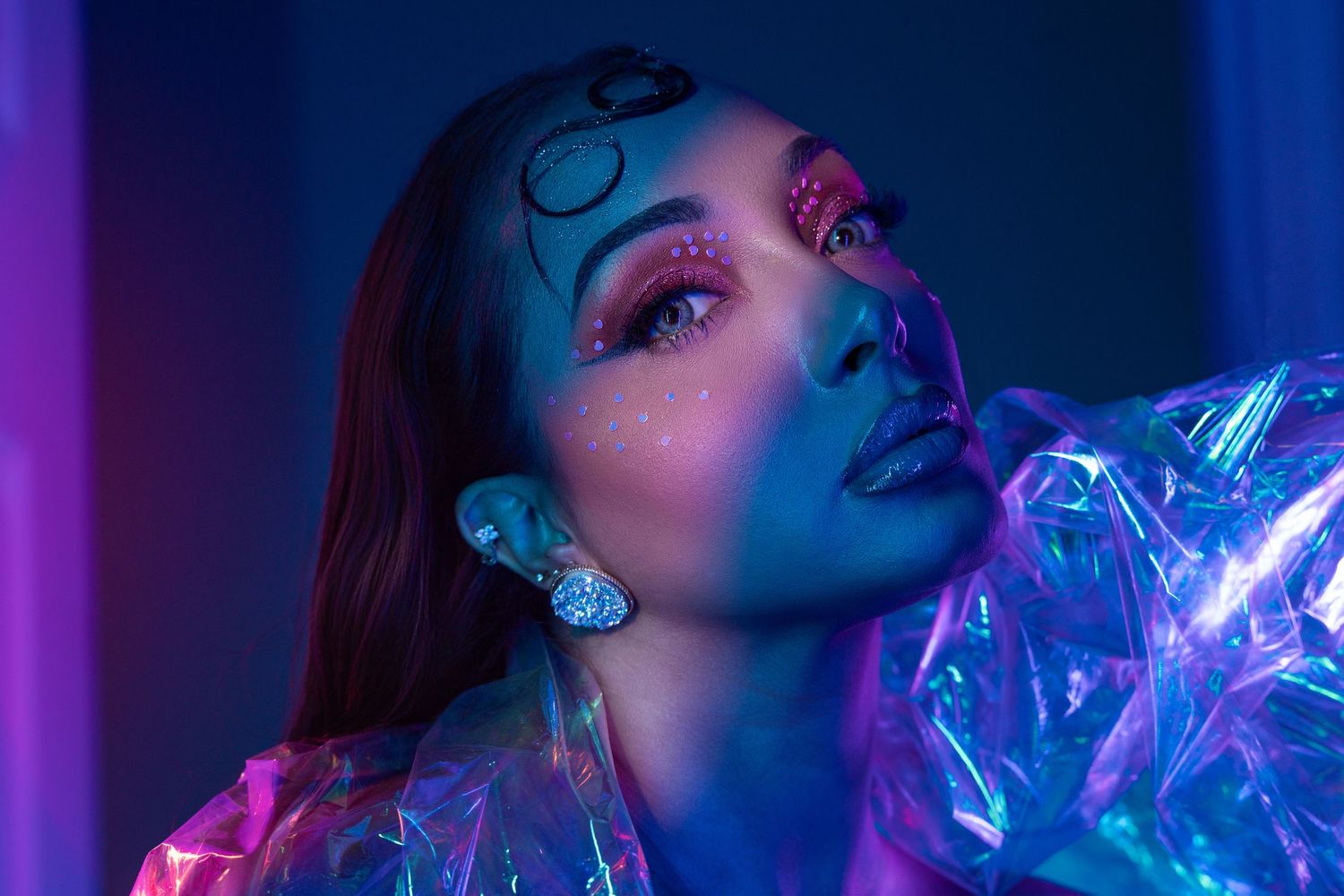 Orlando creative portrait photographer Ray Alvarez — editorial glamour portrait with bold neon blue and purple lighting and avant garde make