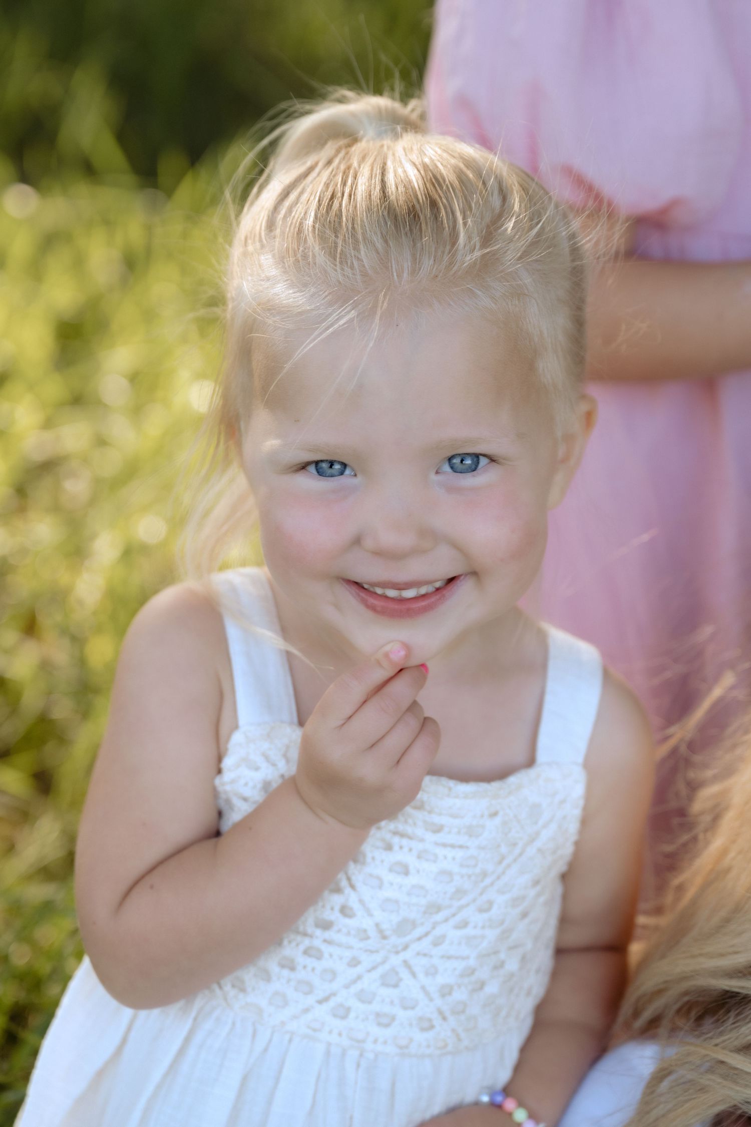 Candid headshot of toddler girl during an outdoor lifestyle spring family session in Hudson, WI