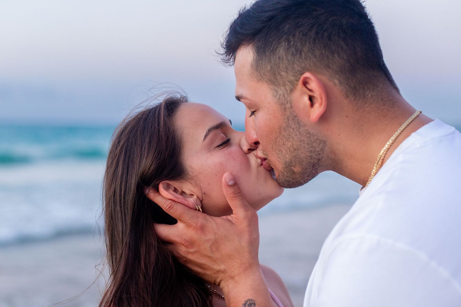 Couples close-up kissing portrait at the beach in Isla Verde, Carolina, Puerto Rico.
