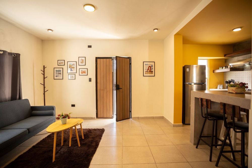 Collage of interior apartment views showing hallways, kitchen counters, and living spaces with warm lighting and modern finishes.