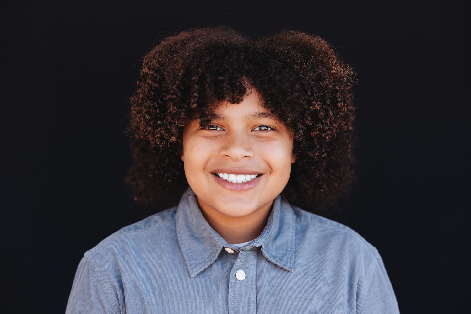 Black and white portrait series showing a child's expressions ranging from serious to joyful.