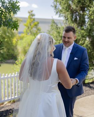 A wedding first look moment captured in sequence showing the bride and groom meeting outdoors by a white fence.