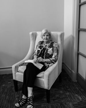 Sequence of black and white photos showing someone reclining in a white armchair with a relaxed pose.