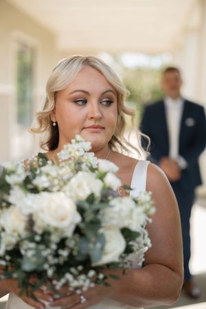 A series of wedding photos showing a woman in white holding an elegant bouquet of white and green flowers.