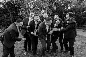 Black and white photos of wedding party members dancing and celebrating outdoors.