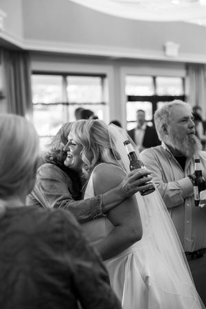 Black and white images capturing emotional moments during wedding preparations indoors.