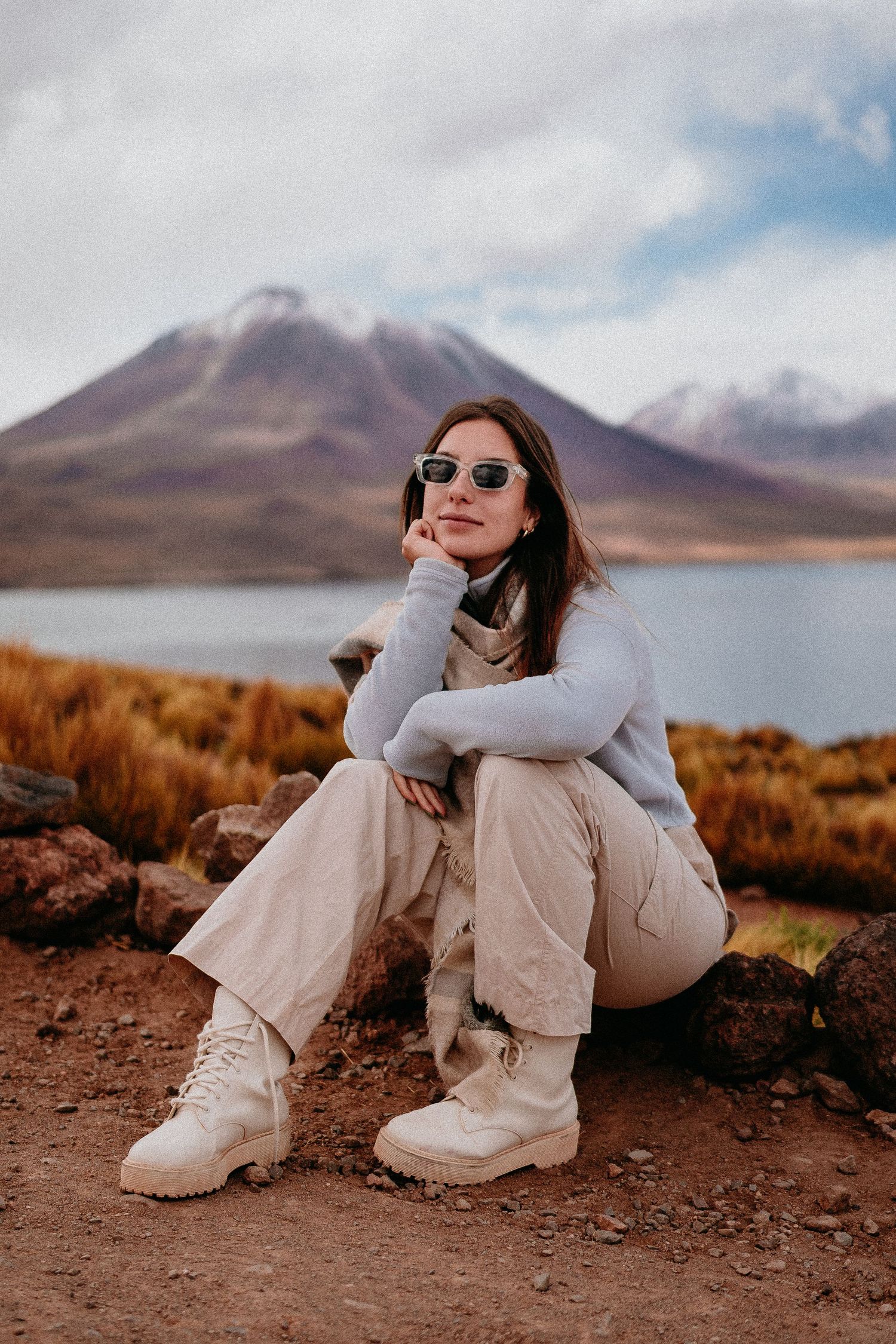 Desert photoshoot with mountain views and a lake in the background.