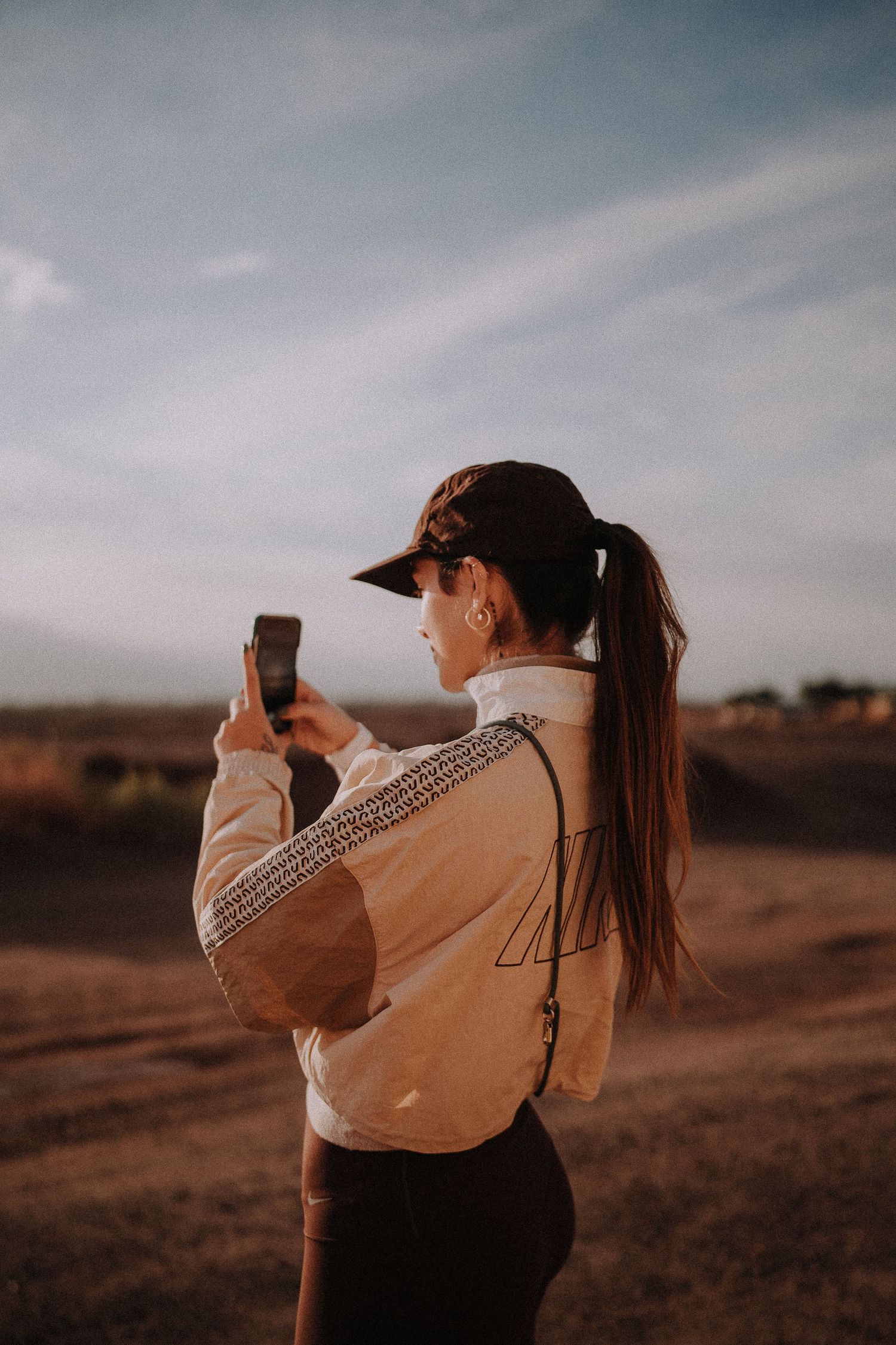 Photographer capturing sunset moments in a desert landscape.