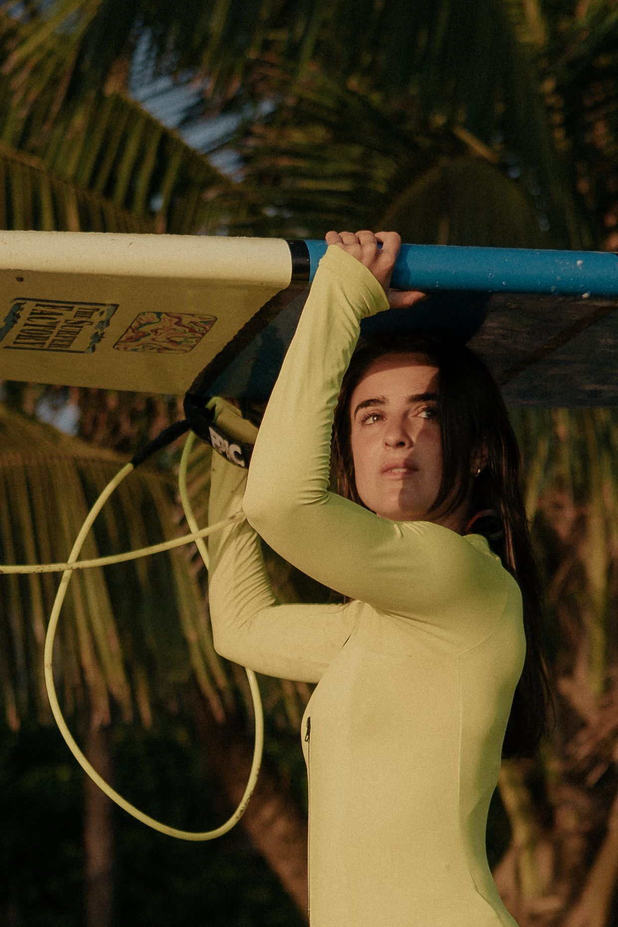 Person in yellow long sleeve shirt performing stretching exercises indoors.