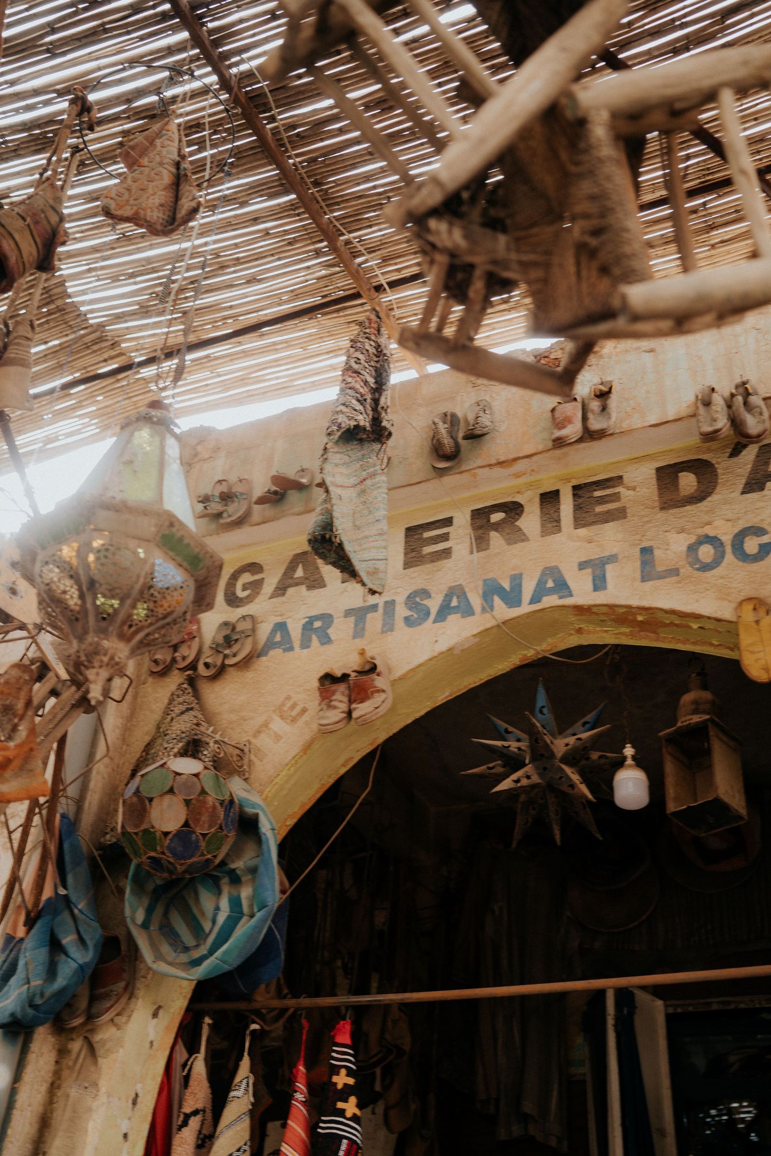 Traditional market signage under a rustic bamboo roof.