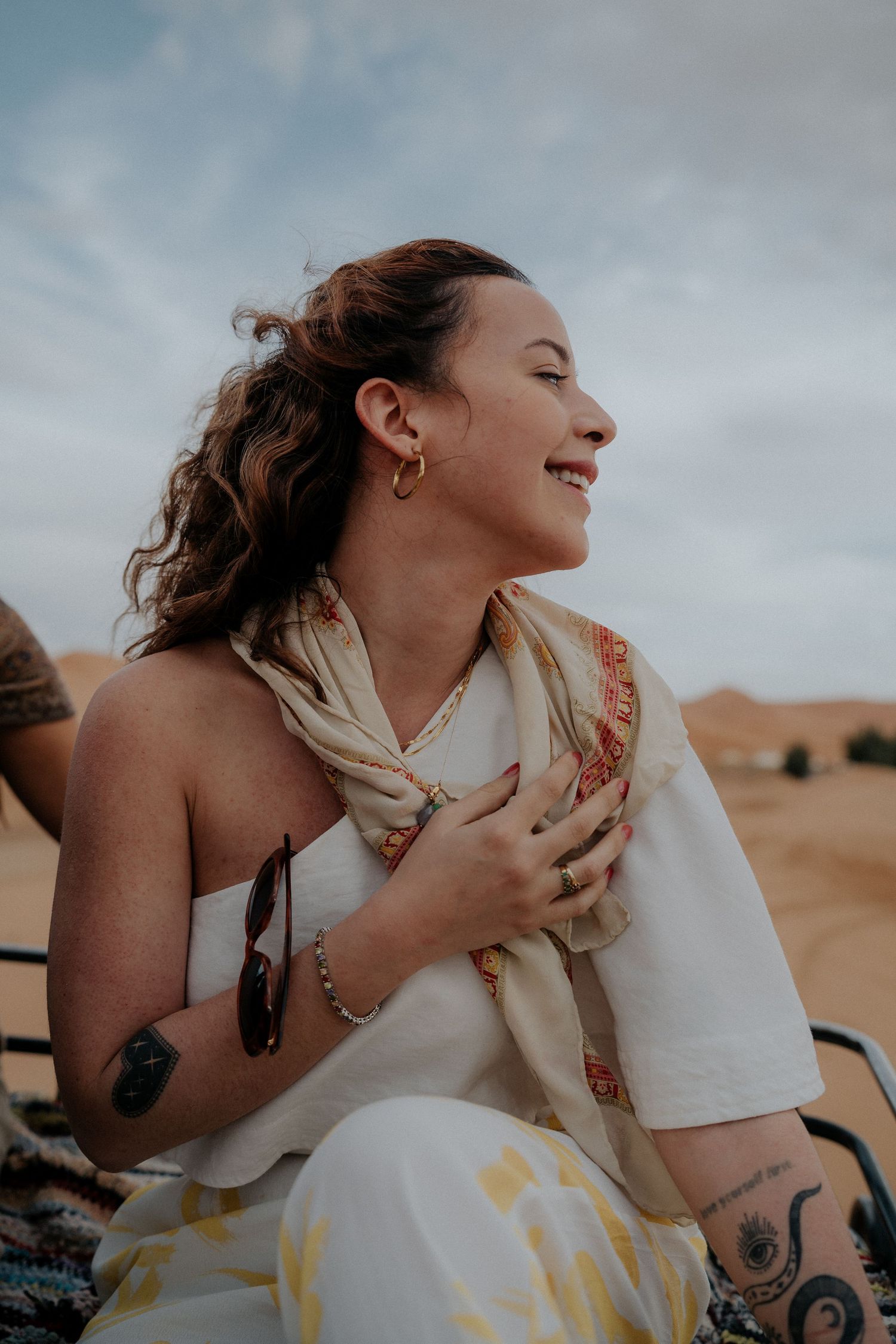Artistic desert photography sequence showing joyful moments against sand dunes.