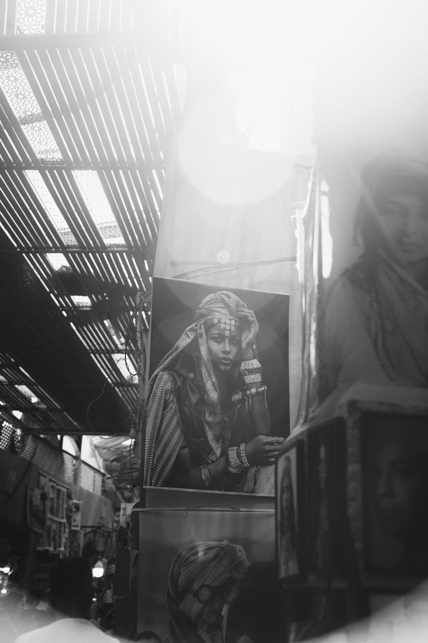Moody black and white photograph of a covered market walkway.