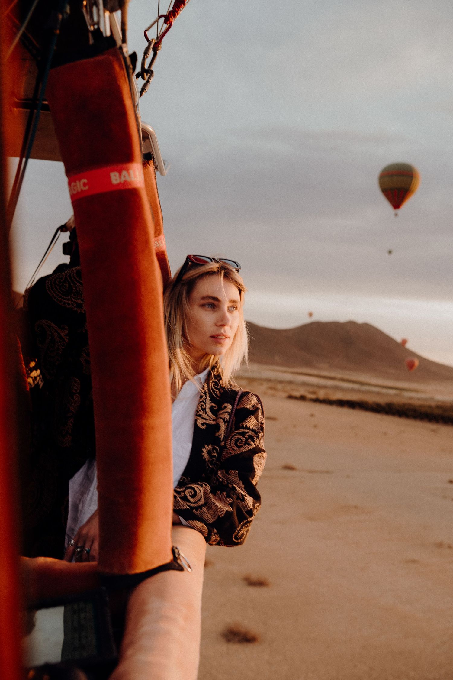 Hot air balloon adventure in desert landscape during golden hour.
