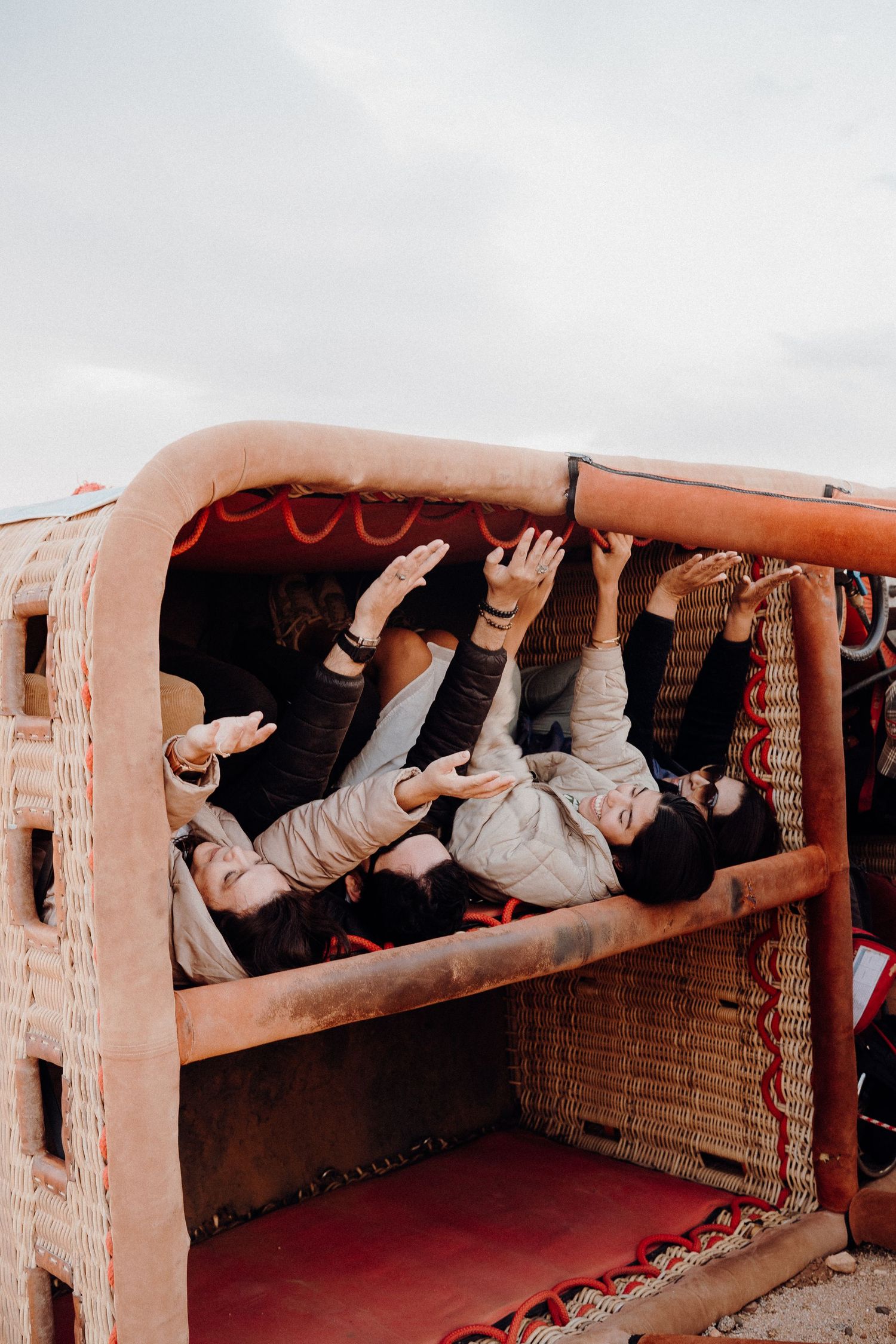 Group enjoying playful moment in traditional Moroccan seating area.