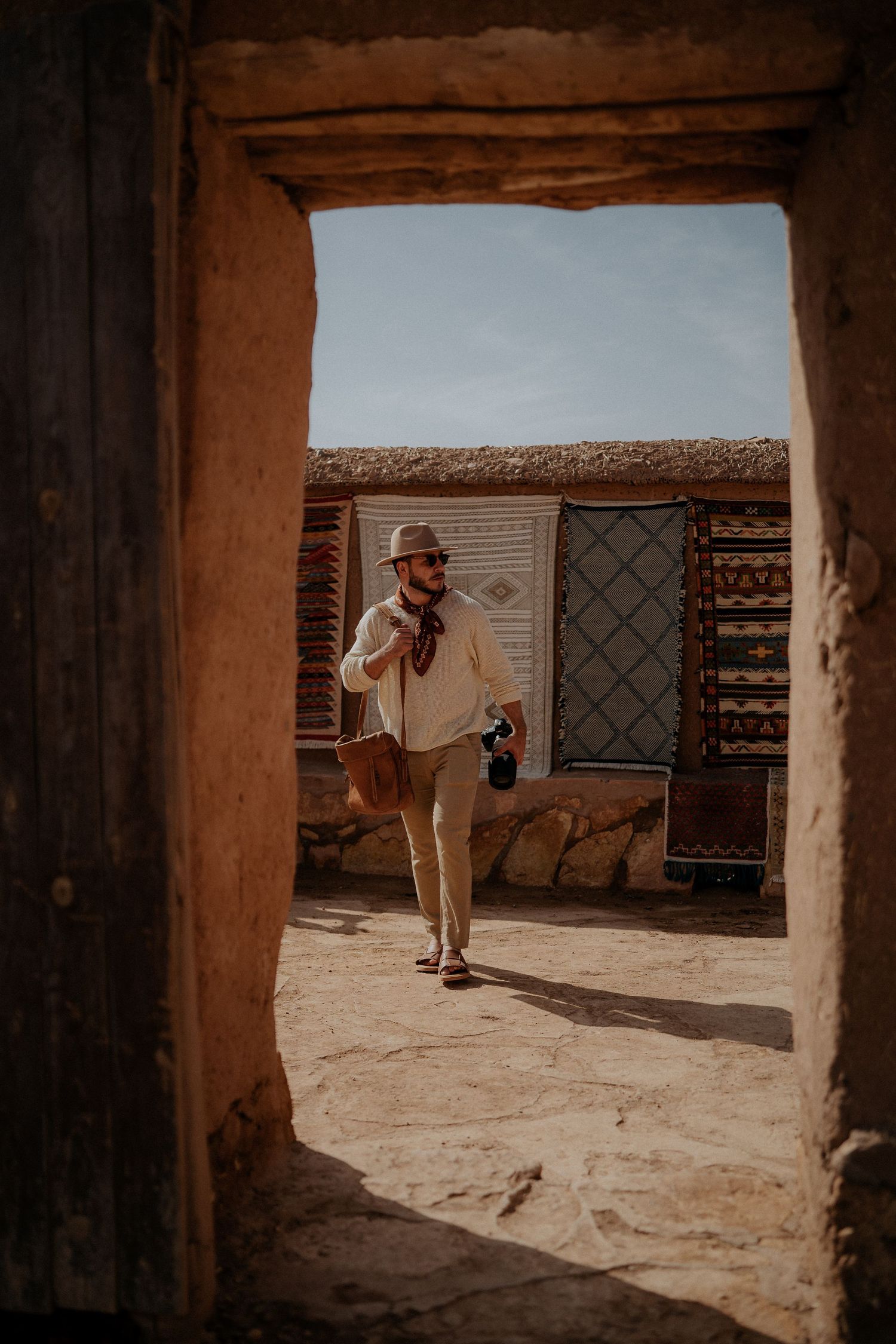Doorway view of sandy courtyard in traditional Moroccan building.