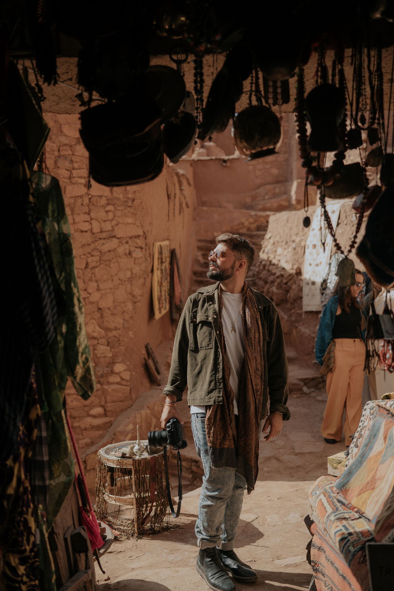 Interior of Moroccan market shop displaying traditional textiles and handicrafts.
