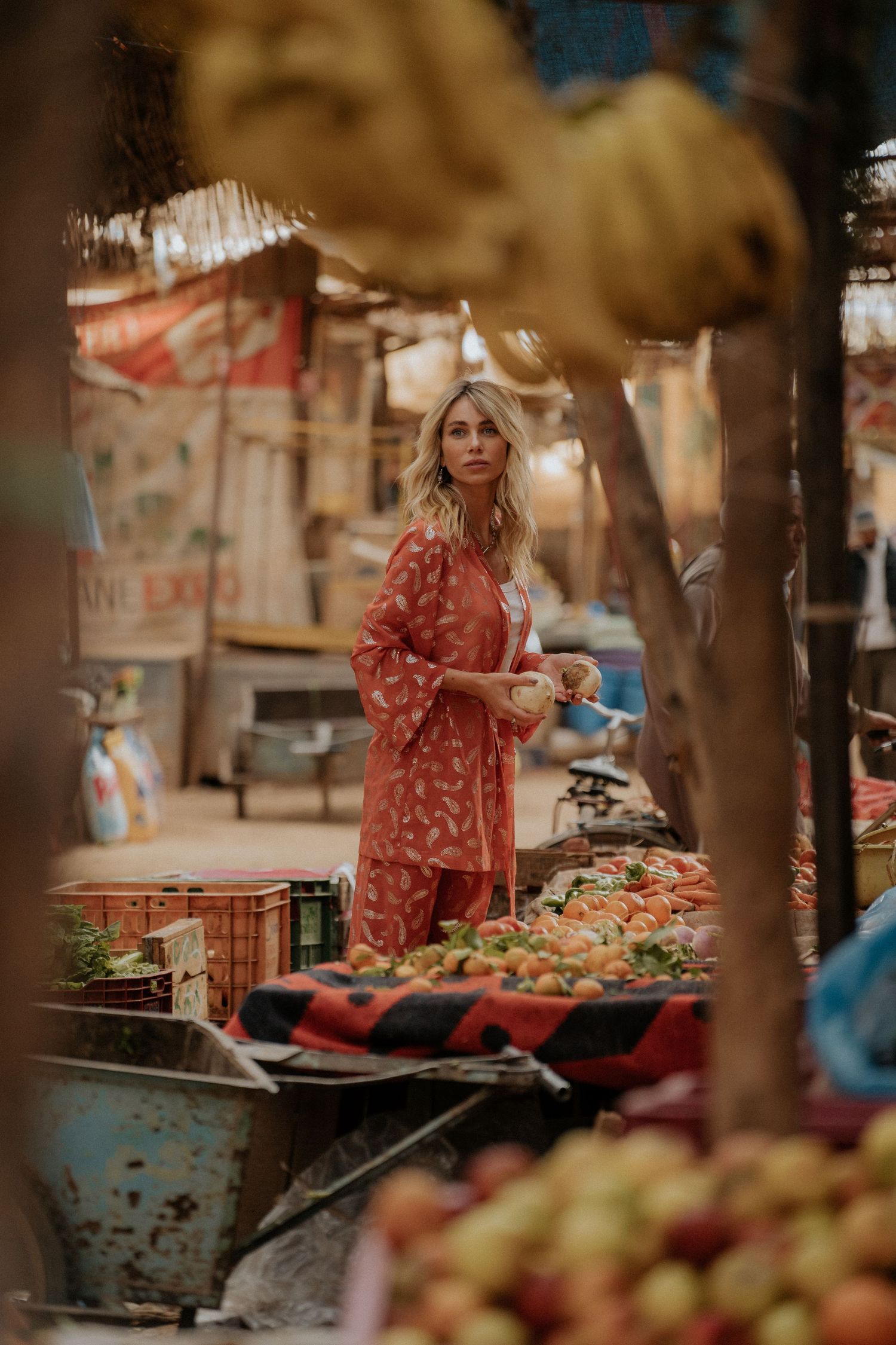 Shopping at a vibrant outdoor market with fresh produce and traditional goods.