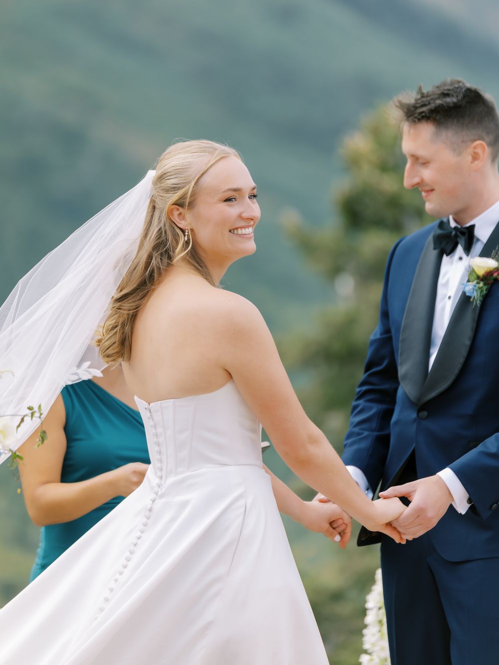 A couple exchanges rings during their mountaintop wedding ceremony.
