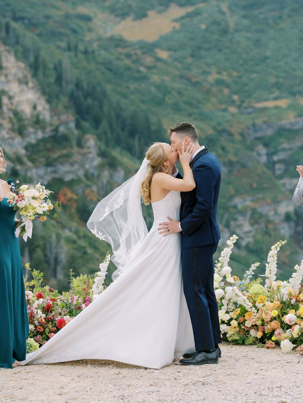 Romantic mountain wedding ceremony with stunning alpine lake backdrop and colorful floral arrangements.
