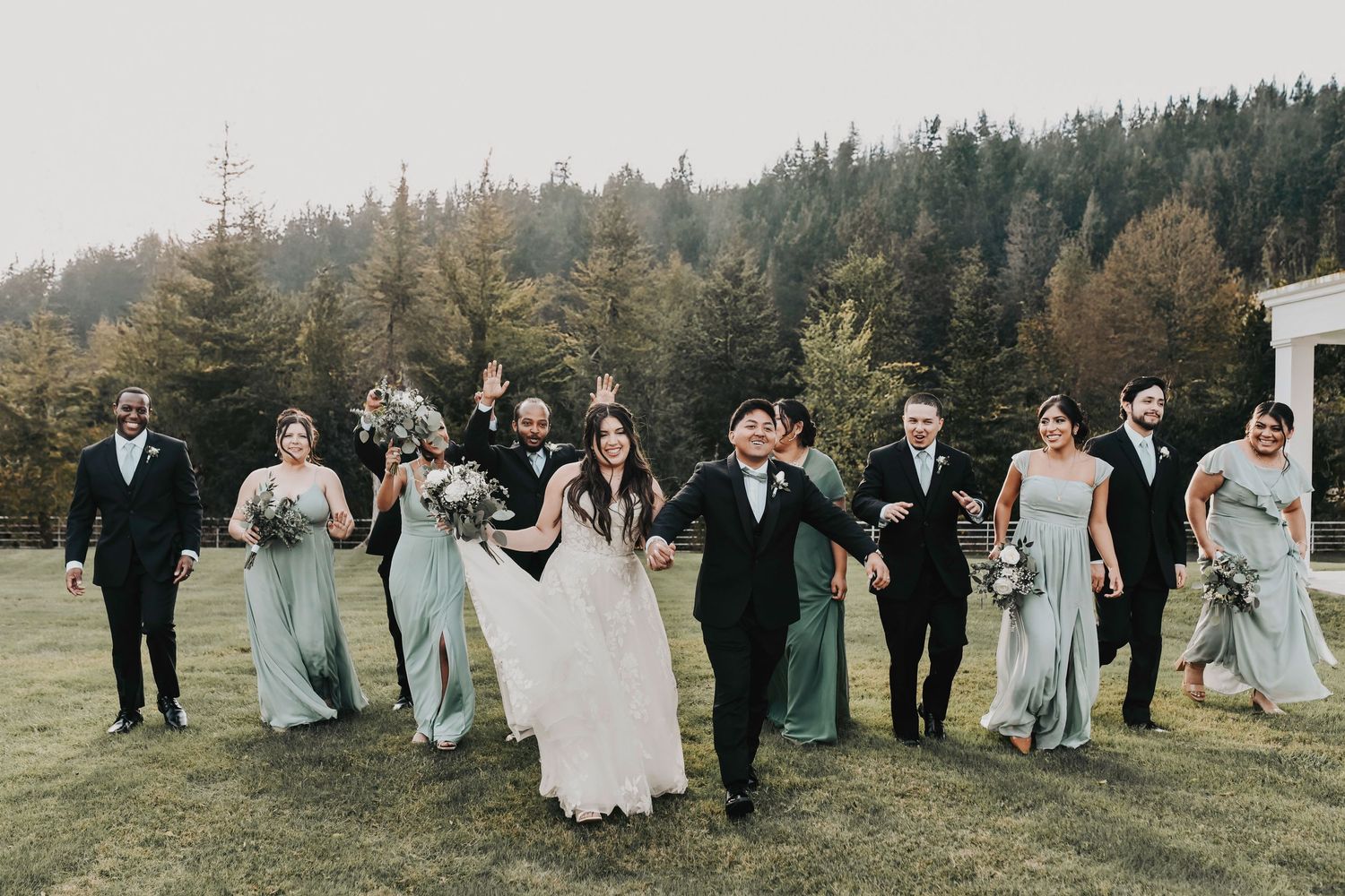 a fun candid wedding photo of the wedding party in green colors at the firefly gardens