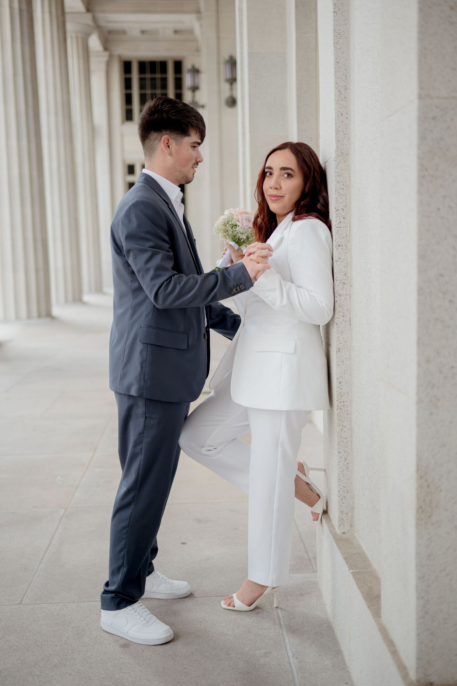Couple in formal attire share intimate moments across three romantic poses against white pillared hallway background.