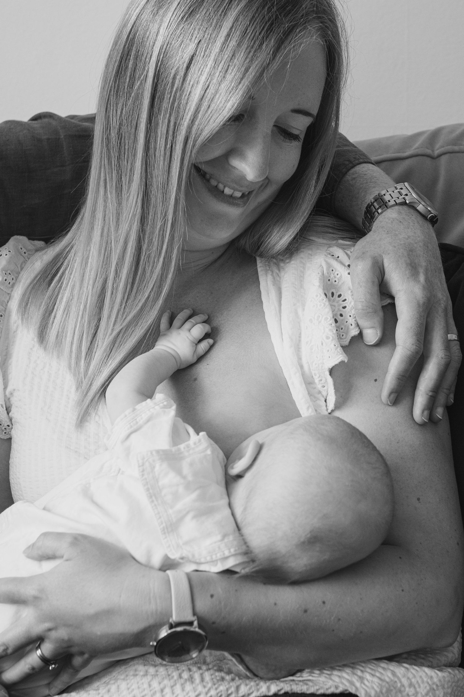 Black and white series showing intimate bonding moments with a newborn.