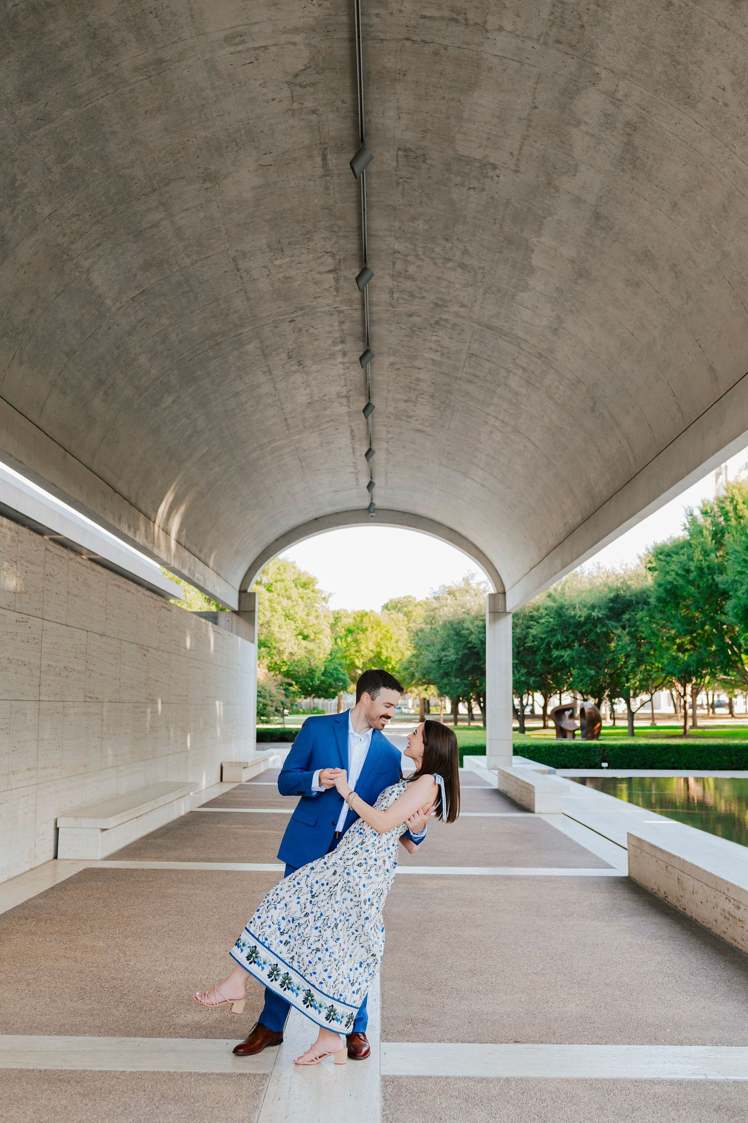 Couple posing in front of the Kimbell Art Museum in Fort Worth during engagement session