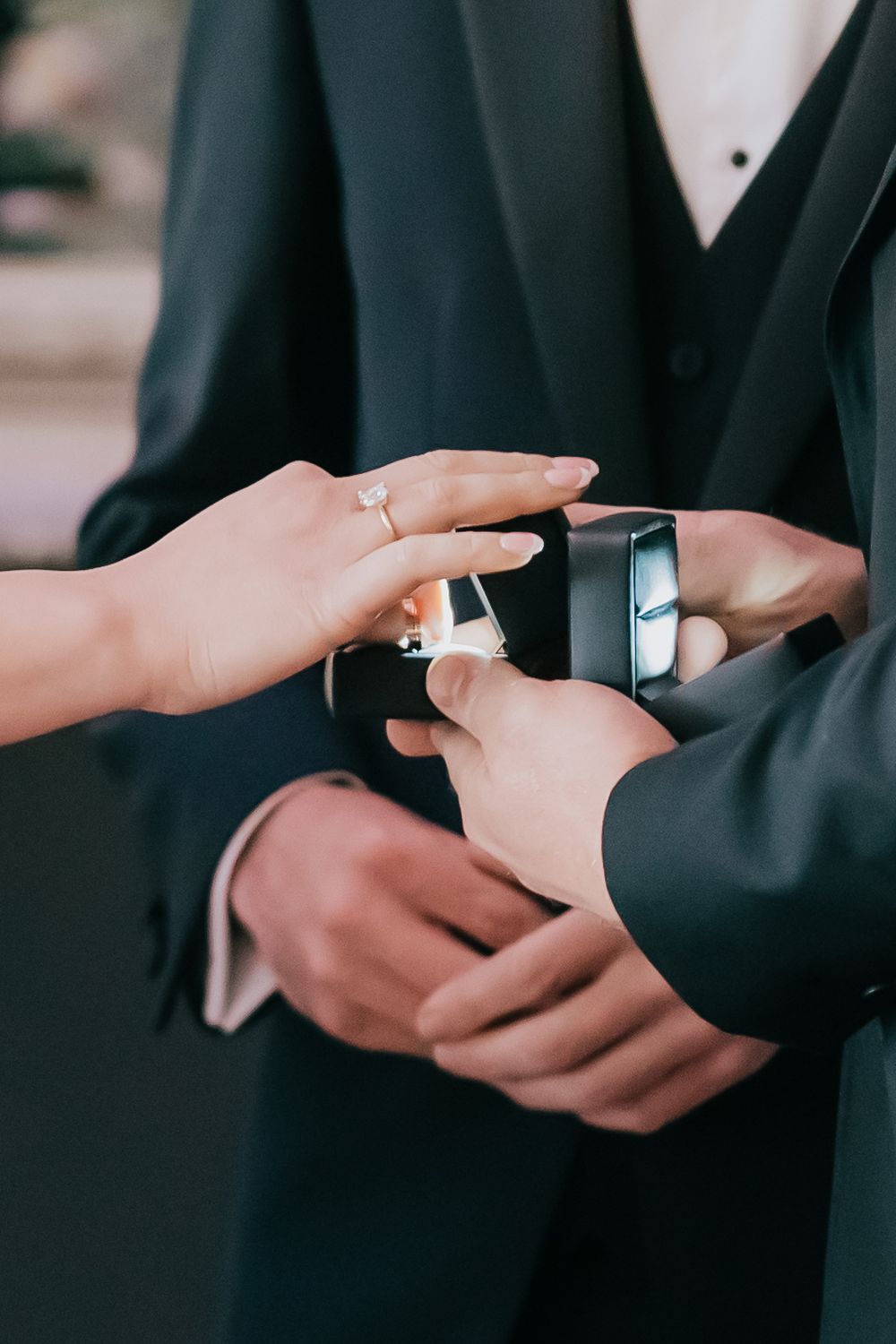 Sequence of hands exchanging wedding rings during a marriage ceremony showing close-up details.