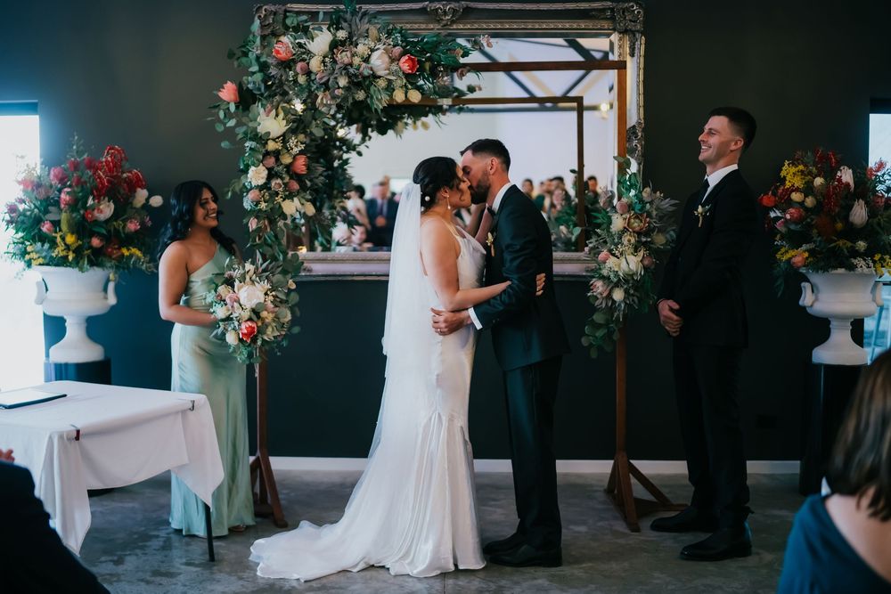 A collection of wedding day moments showing candid interactions and elegant decor at an indoor venue with floral arrangements.