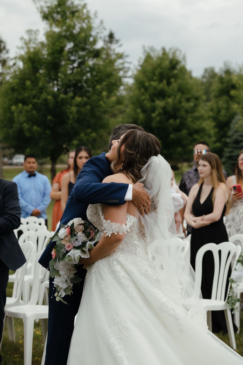 Sequence of photos showing wedding ceremony kiss with white chairs and outdoor garden setting in the background.